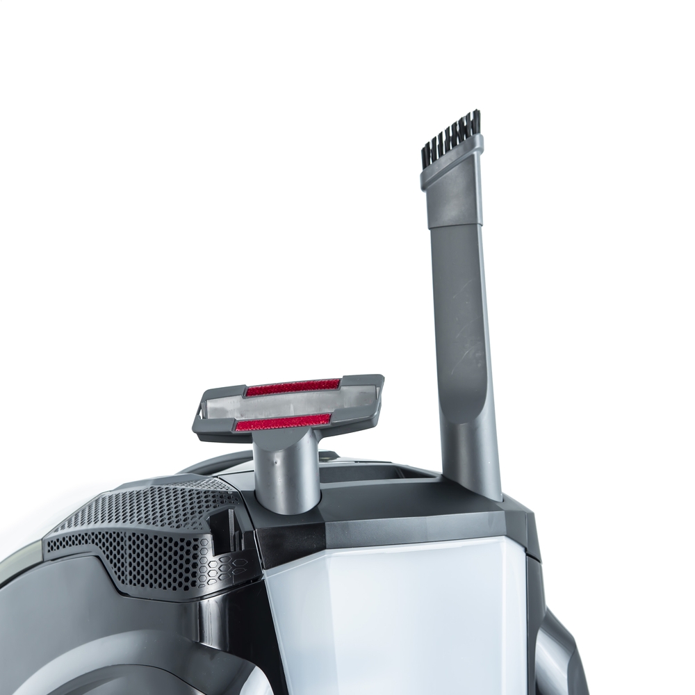 Upholstered furniture and crevice nozzle with a brush head are conveniently located on the body of the vacuum cleaner